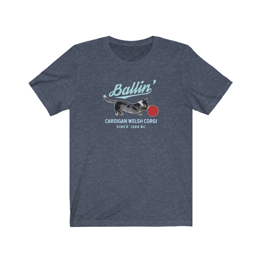Navy short sleeve tshirt on white background. Shirt says Ballin in large script, with a blue merle Cardigan corgi design